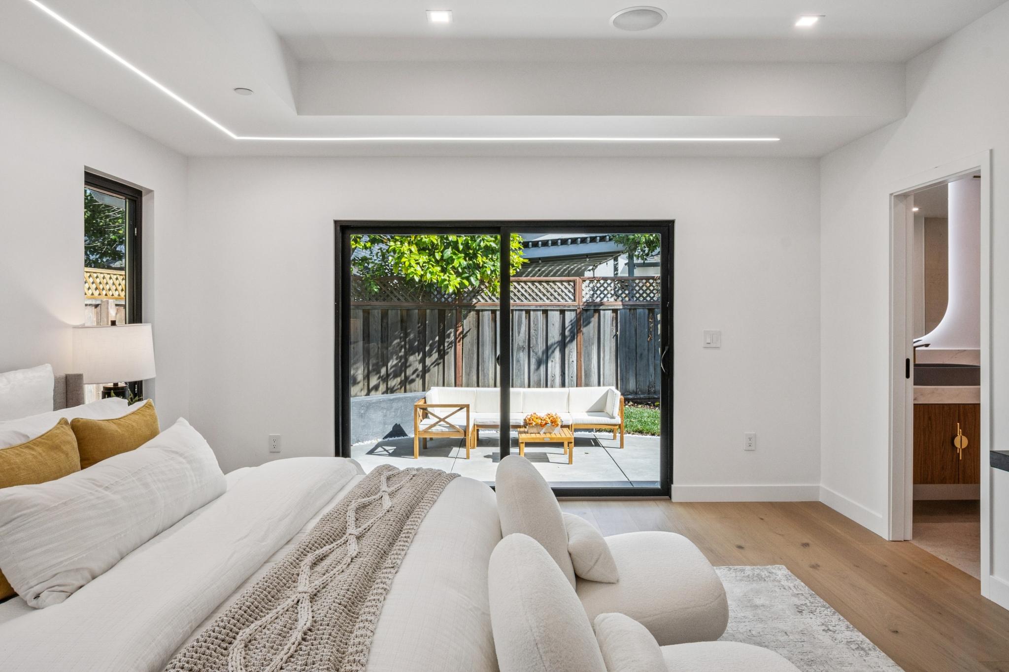 High-end luxury bedroom design concept in Willow Glen, San Jose, optimized for ambient natural light and an effortless connection to the outdoor lounge area.