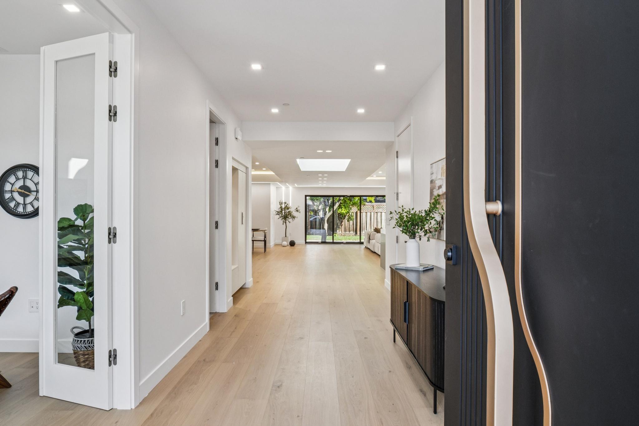 Bright modern entryway and long interior foyer corridor opening up into a luxury open-concept custom home in Willow Glen, San Jose.